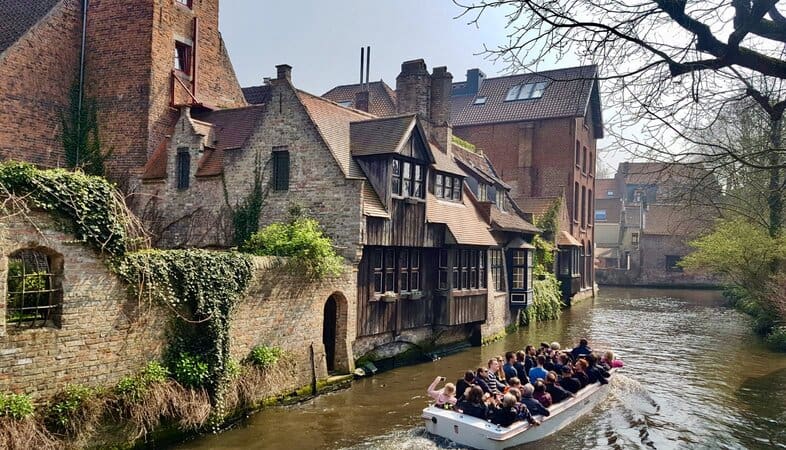 A boat going through the canals of Bruges in Belgium