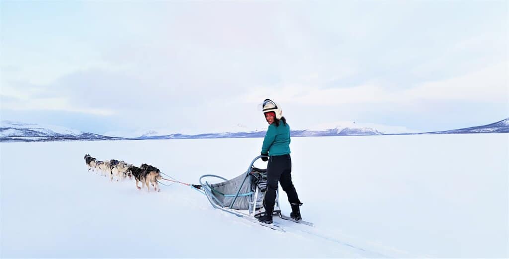 Nimarta Bawa Dog sledding across a frozen lake in Finland