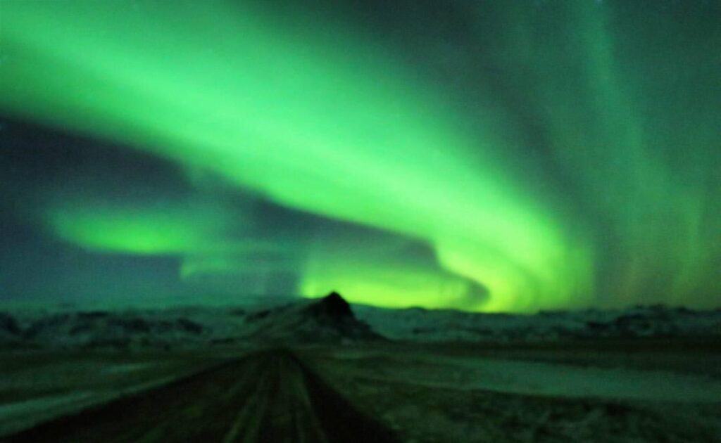 northern lights on a road in the Arctic