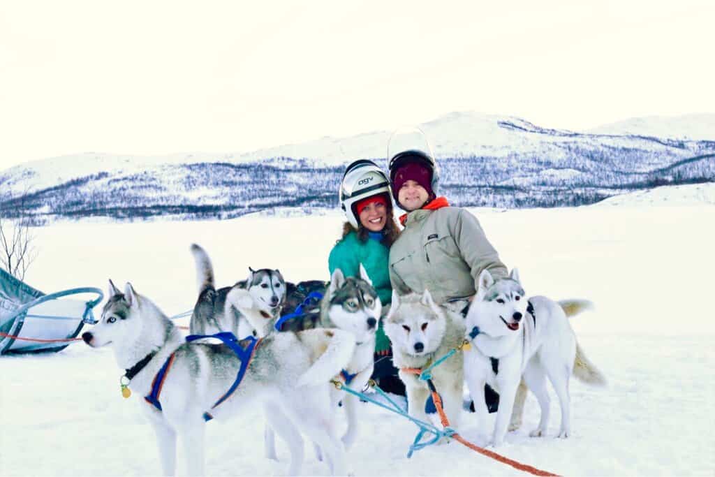 Chris Heckmann and Nimarta Bawa dogsledding in Kilpisjarvi, Finland