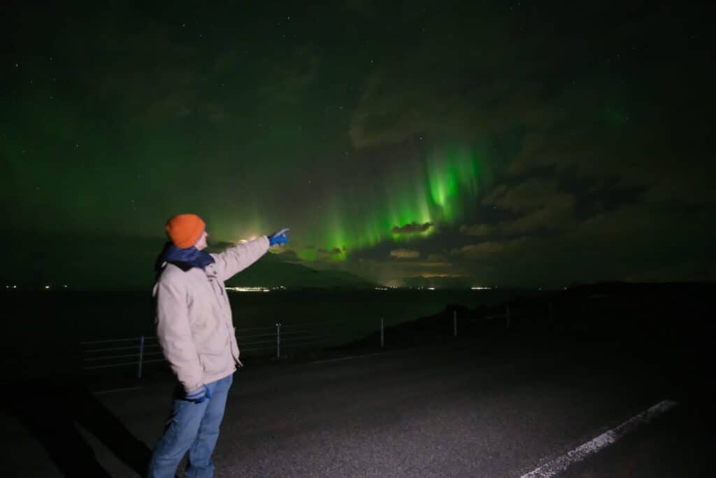 Chris Heckmann under the Northern Lights in Akureyri, Iceland