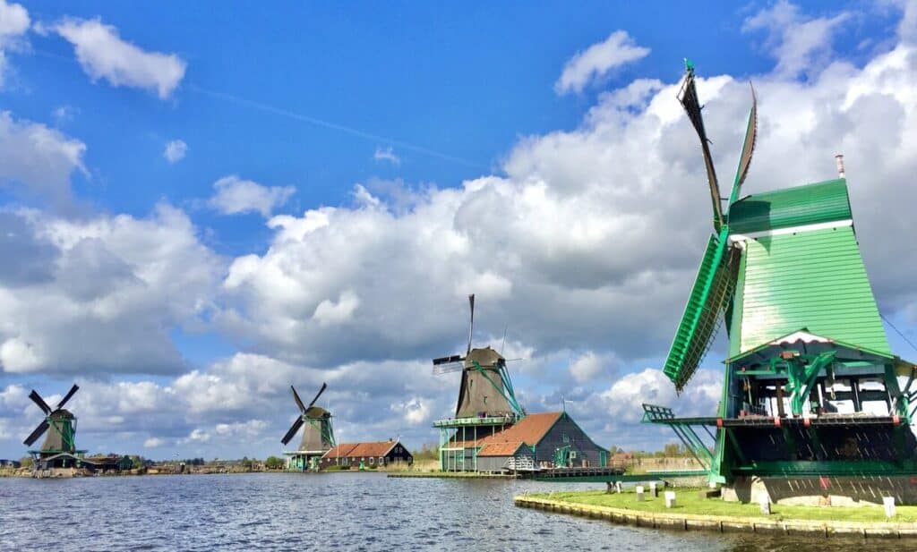 Zaanse Schans in the Netherlands showing four windmills along the river