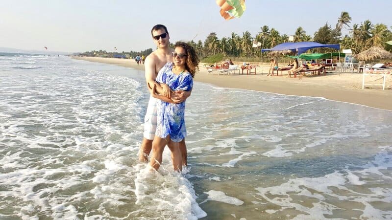 A couple in the water at a Goa beach