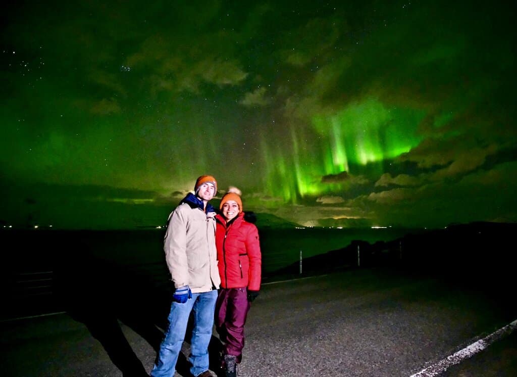 Chris Heckmann and Nimarta Bawa in Akureyri under the northern lights