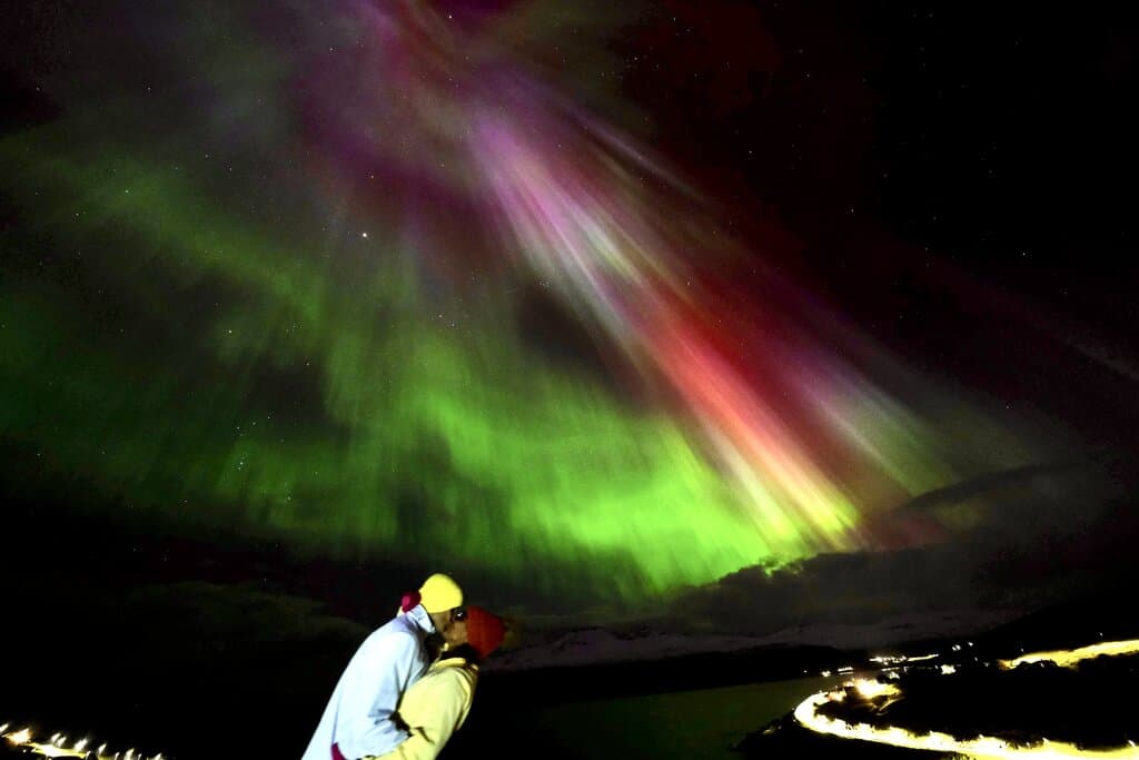 a kiss under the northern lights in the Faroe Islands