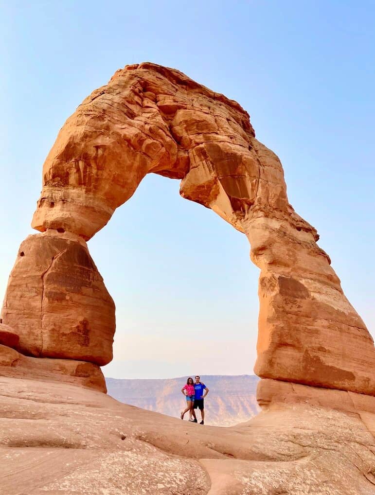 Chris Heckmann and Nimarta Bawa under Delicate Arch in Arches National Park