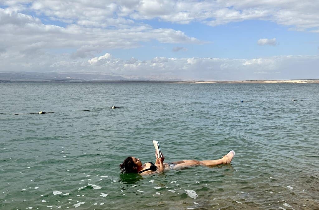floating in the dead sea reading a book