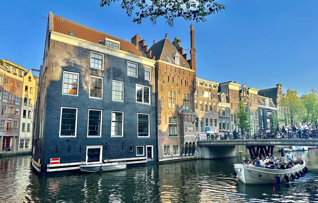 a boat going down a canal in Amsterdam