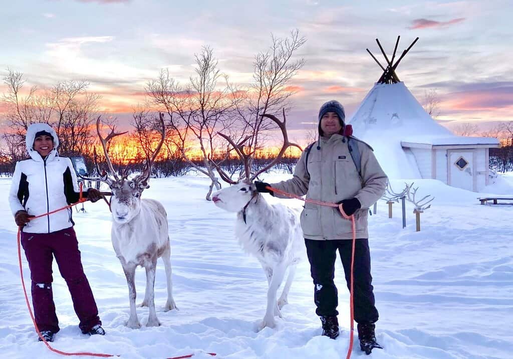 Chris Heckmann and Nimarta Bawa reindeer sledding in Norway