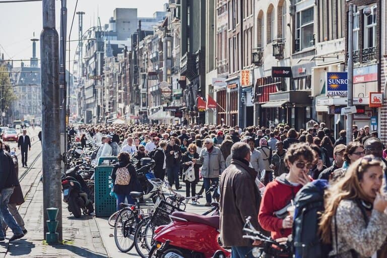 crowded street in Amsterdam showing overtourism