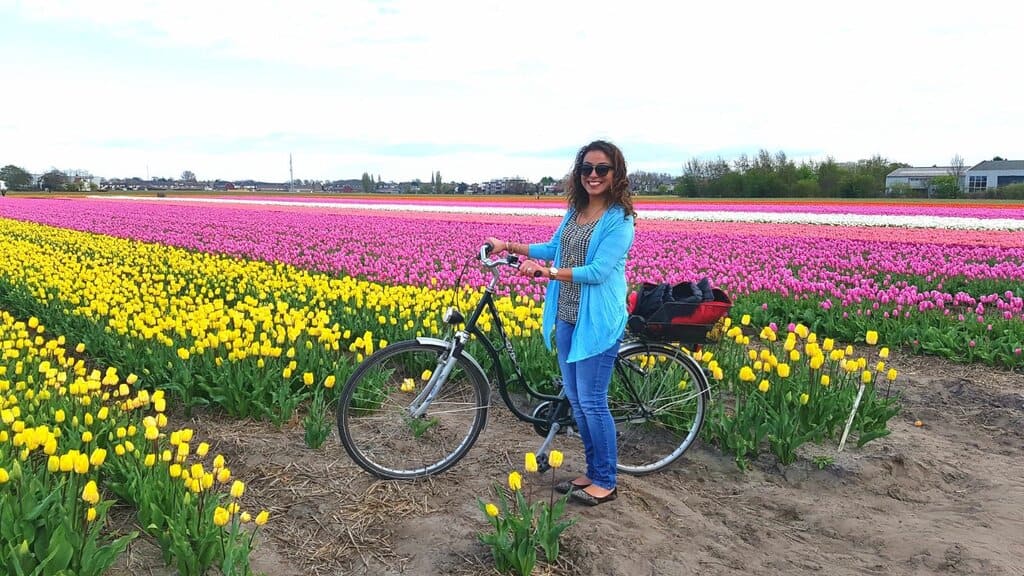 Nimarta Bawa with her bike in the flower fiends of the Netherlands