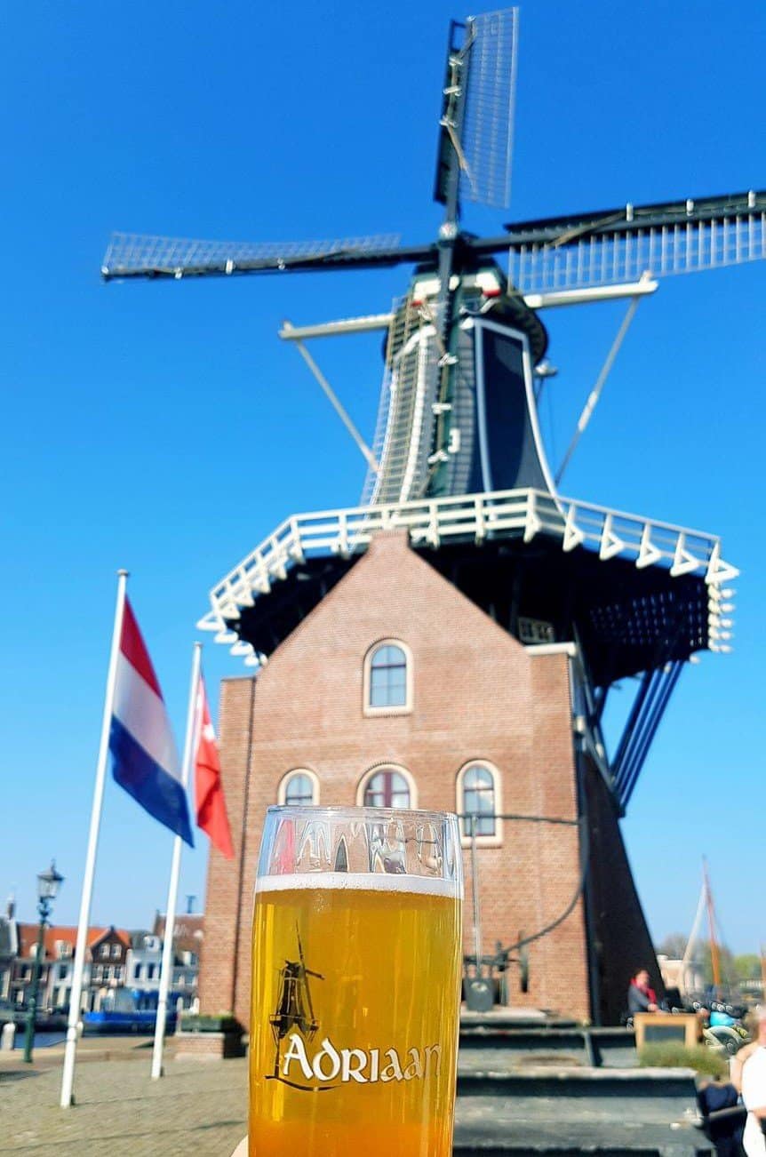 Molen de Adriaan in Haarlem with a local Adriaan beer in front of it