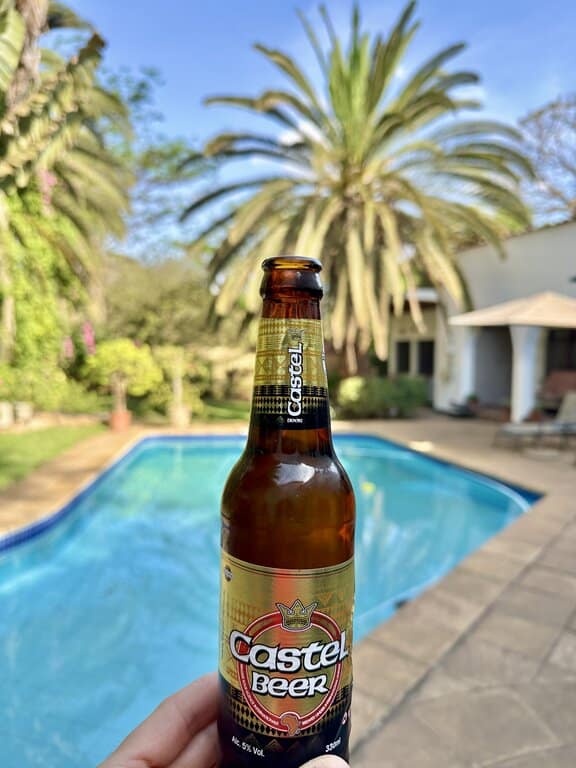 a Castel beer in front of a pool in Lilongwe Malawi