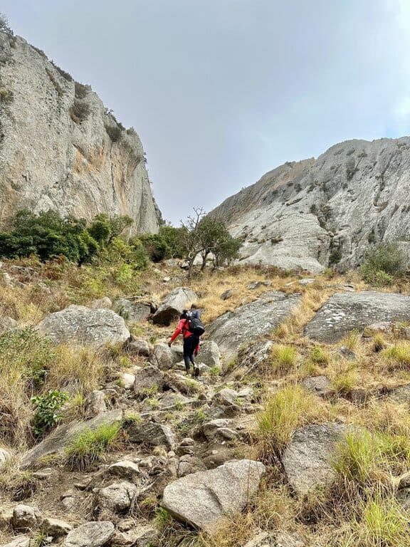 A hiker ascending to the peak of Nkhoma mountain in Malawi
