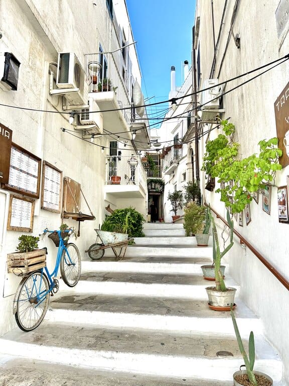 a street with stairs in Ostuni, Italy