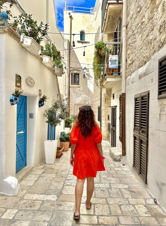 Nimarta Bawa on a narrow street in Polignano a Mare