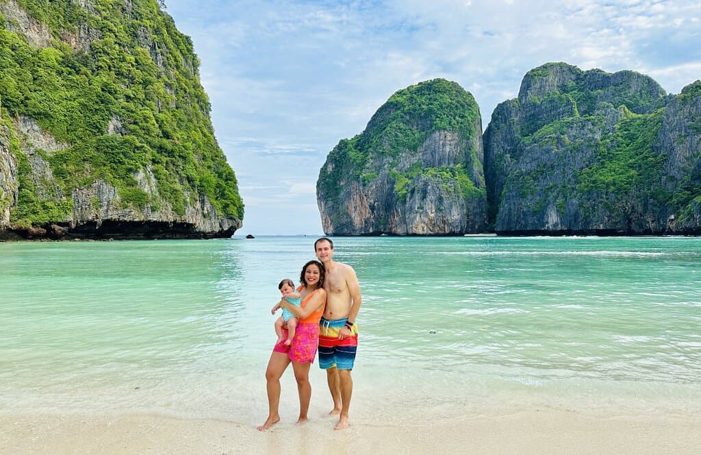 Chris Heckmann and Nimarta Bawa with baby at Maya Bay in Thailand