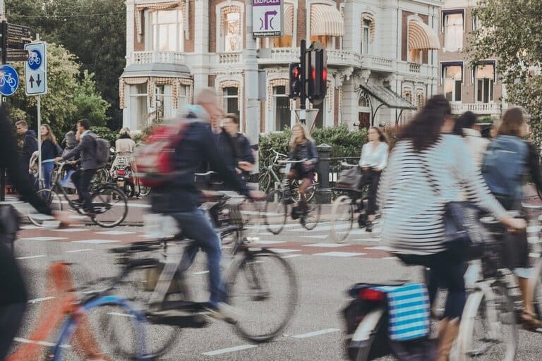 people biking through central Amsterdam