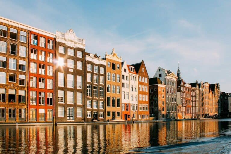 A photo of houses coming out of the canals in Amsterdam