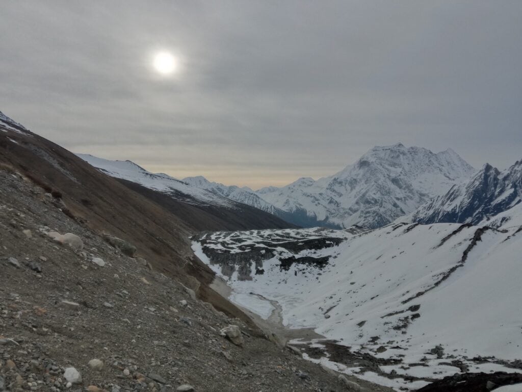 the sun shining through the Himalayas